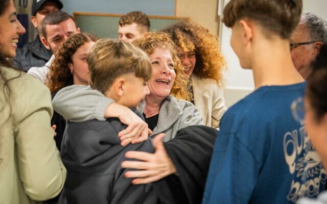 Meirav Tal embraces her partner, Yair Yaakov's boys, Or and Yagil Yaakov, also released from captivity, at Tel Aviv's Ichilov Hospital after she was released as a hostage by the Gaza-ruling Hamas terror group, November 28, 2023. (Courtesy)
