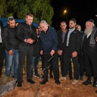 Prime Minister Benjamin Netanyahu, center, lays the foundation stone for a new community, Ofir, as he meets with municipal leaders of communities close to the Gaza Strip, November 29, 2023. (Kobi Gideon/GPO)