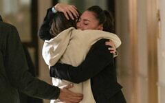 Moran Stela Yanai, 40, embraces family members at Sheba Medical Center after being released on November 29, 2023 from Gaza, where she was held by Hamas terrorists for 54 days (courtesy)