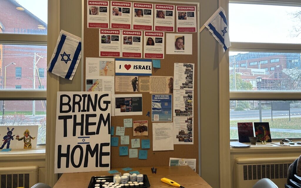 Posters of kidnapped Israelis hang inside the common room of the Hillel House at the University of Connecticut in Storrs, November 2023. (Cathryn J. Prince)