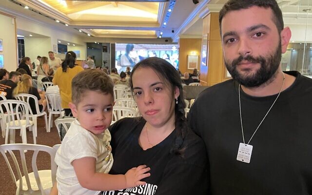 Omer Waiss, his wife Zemer, and two-year old son Amit await news of the release of hostages from Kibbutz Be’eri, November 29, 2023. (Jeremy Sharon/Times of Israel)