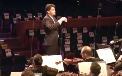 Israel Philharmonic maestro Lahav Shani performing a live broadcast concert on October 22, 2023, playing to the faces of the Hamas hostages (Courtesy)