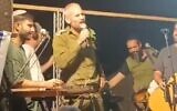 Cpt. Amichai Friedman, rabbi of the Nahal battalion military base, speaks to soldiers from a stage, November 4, 2023. (X video screenshot: used in accordance with Clause 27a of the Copyright Law)