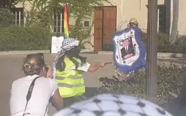Pro-Palestinian students at the University of California, Los Angeles, strikes a pinata plastered with a picture of Prime Minister Benjamin Netanyahu on November 8, 2023. (Screen capture/X; used in accordance with Clause 27a of the Copyright Law)