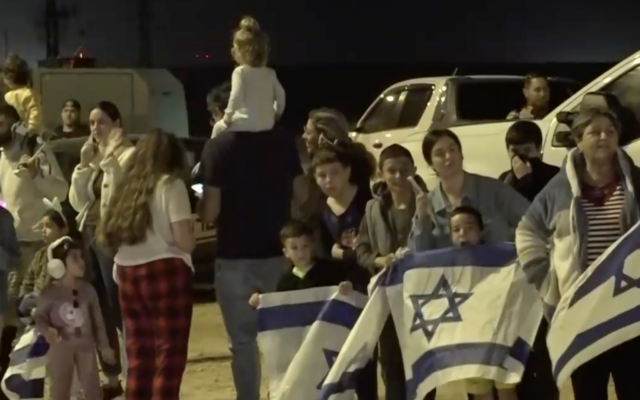 Israelis await the arrival of 13 Israeli hostages released by Hamas on the third day of the four-day ceasefire, November 26, 2023. (Screenshot)