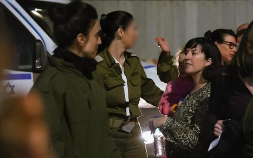 Adi Shoham and her three-year-old daughter Yahel are received by IDF soldiers after being freed from captivity in Gaza, November 25, 2023. (Israel Defense Forces)
