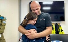 Hila Rotem Shoshani, 13, is embraced by her uncle Yair Rotem as they reunite, in the early hours of November 26, 2023. (Israel Defense Forces)