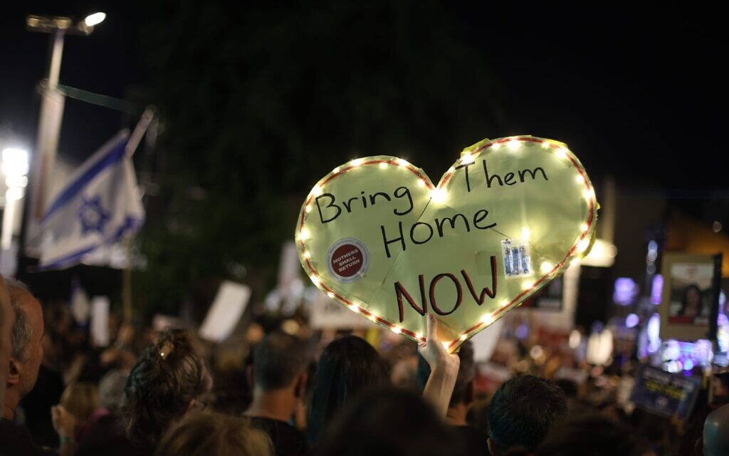 A demonstrator waves a sign calling for the release of hostages held by terrorists in Gaza during a rally on November 25, 2023, at Tel Aviv's Hostages Square. (Courtesy Amir Yarchi)