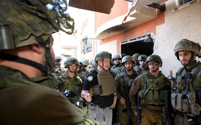 Prime Minister Benjamin Netanyahu (center) speaks with soldiers inside the northern Gaza Strip on November 26, 2023. (Avi Ohayon/GPO)