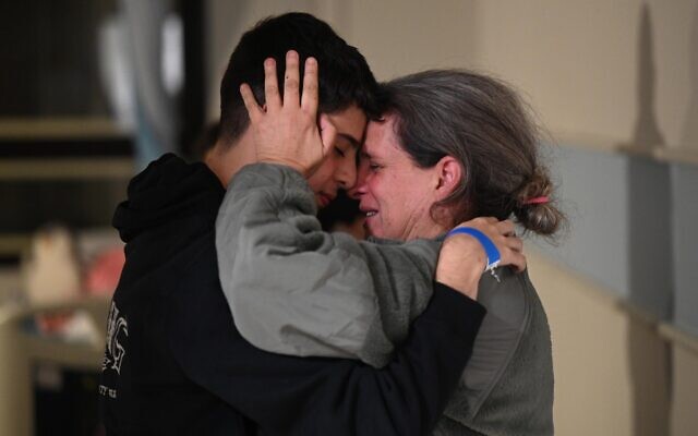 Sharon Avigdori greets her son, Omer, in the early hours of November 26, 2023, after she was released from 50 days of Hamas captivity. (Haim Zach/ GPO)