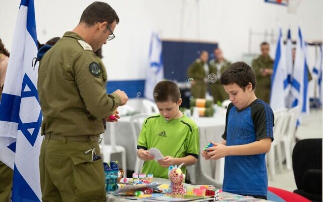 Gal and Tal Almog-Goldstein play with toys at the IDF Hatzerim airbase following their release from Gaza on November 26, 2023. (Courtesy)