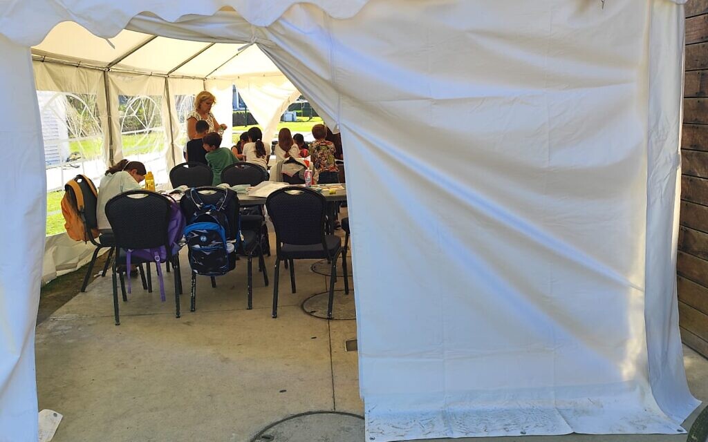 Class held in a temporary  tent classroom, in Kibbutz Nachshonim on November 15, 2023. (Gavriel Fiske/Times of Israel)