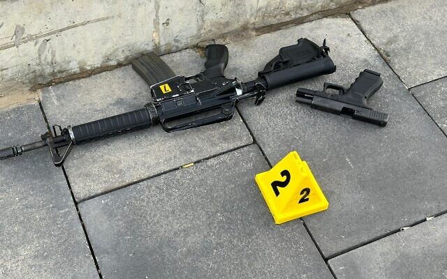 A handout photo of a rifle and pistol found at the scene of a shooting terror attack in Jerusalem, November 30, 2023. (Israel Police)
