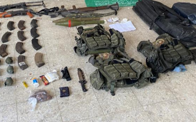 Weapons and Hamas equipment found by IDF troops in Gaza City's al-Karmel school, November 17, 2023. (Israel Defense Forces)