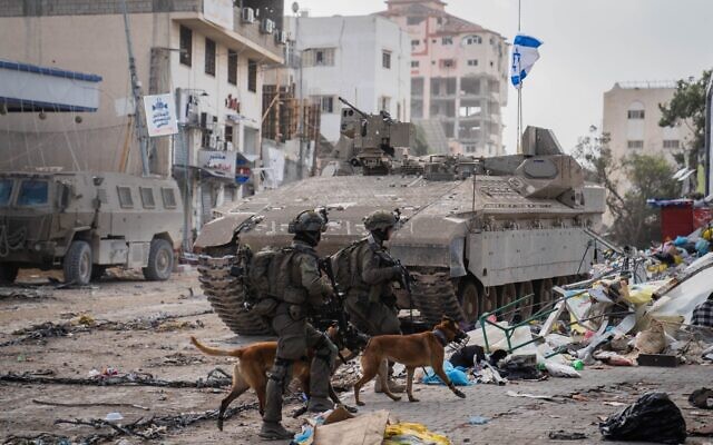 Troops and dogs of the Oketz canine unit are seen in the Gaza Strip, in a handout image published November 26, 2023 (Israel Defense Forces)
