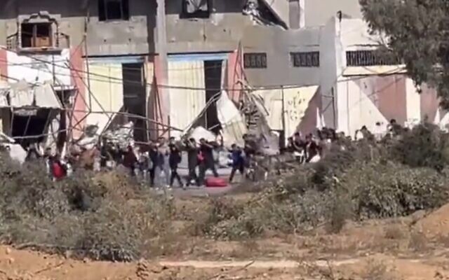 A screengrab from a video posted by the IDF's Arabic-language spokesperson showing Gazans carrying white flags and with arms raised moving south after the military said it would allow safe passage, November 7, 2023. (Screenshot X, Used in accordance with Clause 27a of the Copyright Law)