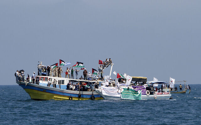 FILE: Palestinians waving national flags wait aboard small boats off the port of Gaza City on May 30, 2010, to greet the so-called 'Freedom Flotilla.' (MAHMUD HAMS / AFP)