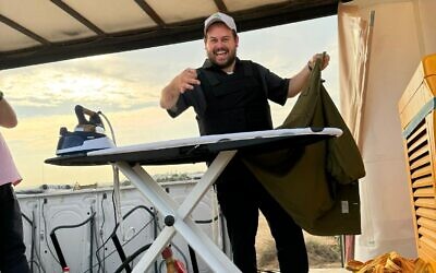 Shai Graucher on a mobile laundry truck his charity provides to IDF soldiers. (courtesy)