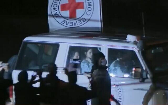 Israeli hostages, including several children, are driven to the Rafah border crossing: A screengrab of live footage from the release on November 25, 2023 of the second group of Israeli hostages from Hamas in Gaza to the Red Cross. (Screen capture)
