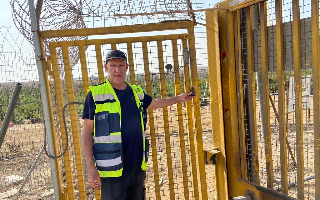 Stevie Marcus pictured on November 13, 2023, at the back gate of Kibbutz Alumim, through which terrorists entered on October 7, 2023 (David Horovitz / Times of Israel)