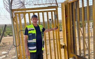 Stevie Marcus pictured on November 13, 2023, at the back gate of Kibbutz Alumim, through which terrorists entered on October 7, 2023 (David Horovitz / Times of Israel)