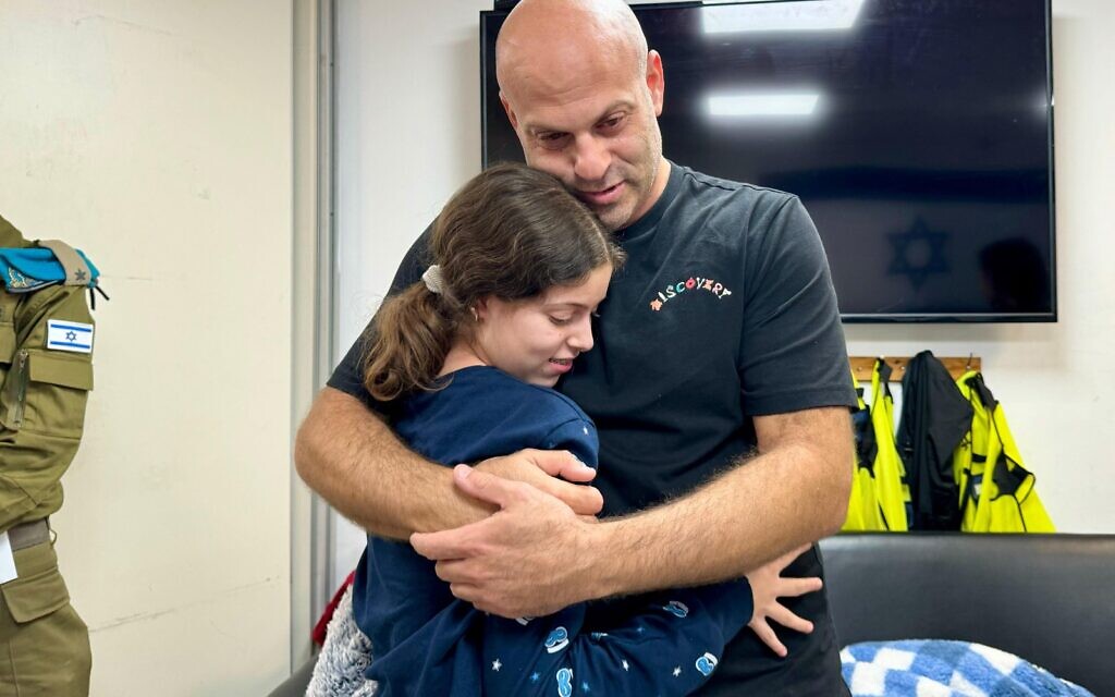 Hila Rotem, 13, is embraced by her uncle as they reunite, in the early hours of November 26, 2023, after she was freed by Hamas. Her mother Raya is still held hostage in Gaza. (Israel Defense Forces)