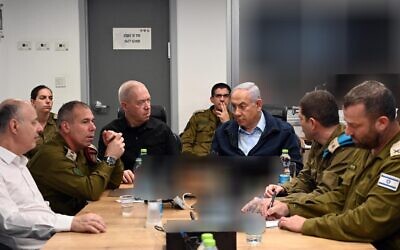 Defense Minister Yoav Gallant (center L) and Prime Minister Benjamin Netanyahu (center R) at the military headquarters during the release of a number of Israeli hostages held in Gaza, November 24, 2023. (Haim Zach/GPO)