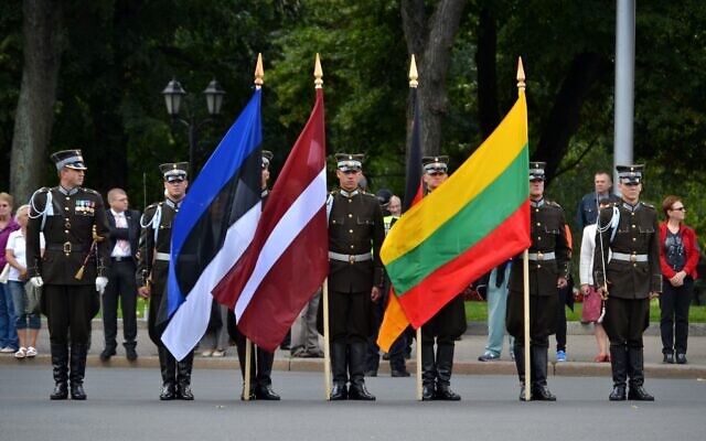 Illustrative: The flags, from left to right, of Estonia, Latvia and Lithuania at a ceremony in Riga, Latvia, in 2012. (Pablo Andrés Rivero via JTA)