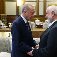 This handout photograph taken and released by the Turkish Presidency Press Office on July 26, 2023, shows Turkish President Recep Tayyip Erdogan (L) welcoming the leader of the Palestinian terror group Hamas, Ismail Haniyeh, (R) during their meeting at the Presidential Complex in Ankara. (Mustafa KAMACI / Turkish Presidency Press Office / AFP)
