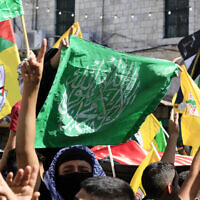 People wave Palestinian, Hamas and Fatah flags during a march in support of the people in the Gaza Strip, in the West Bank city of Nablus on October 26, 2023 (Zain JAAFAR / AFP)