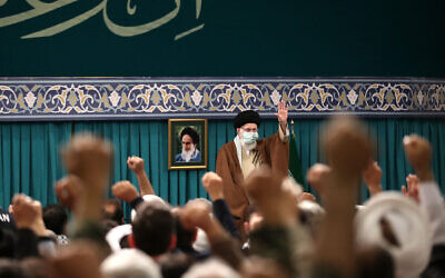 A handout picture provided by the office of Iran's Supreme Leader Ayatollah Ali Khamenei on November 29, 2023, shows him greeting members of the Basij ahead of a speech in Tehran. (KHAMENEI.IR / AFP)
