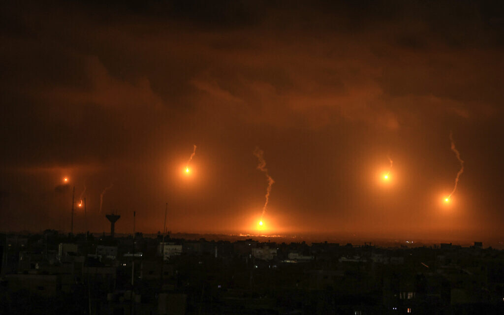 Israeli flares light the sky above Khan Younis in the southern Gaza Strip, on December 1, 2023. (Photo by SAID KHATIB / AFP)