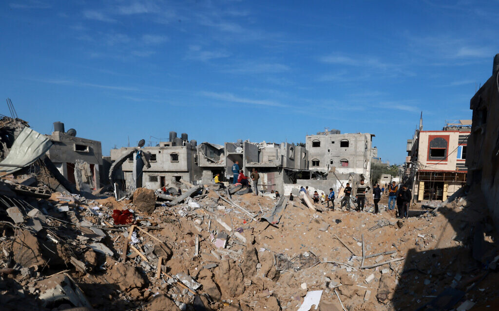 Palestinians check the damage next to a crater following Israeli air strikes in Rafah in the southern Gaza Strip, early on December 4, 2023. (MOHAMMED ABED / AFP)