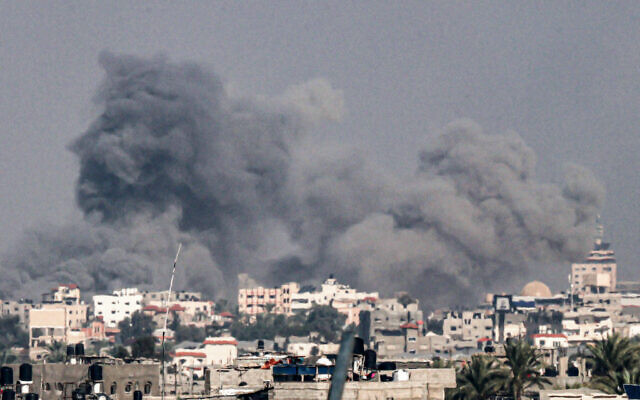 A picture taken from Rafah shows smoke billowing following Israeli strikes in Khan Younis on the southern Gaza Strip on December 7, 2023. (Said Khatib/AFP)