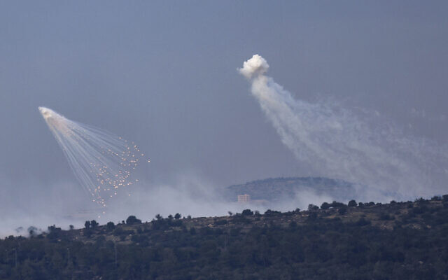 A picture taken from the Israeli side of border with Lebanon shows shells exploding over hills around the southern Lebanese village of Aita al-Shaab on December 8, 2023. (Jalaa Marey/AFP)