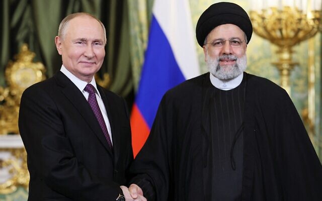 Russian President Vladimir Putin (left) shakes hands with Iranian President Ebrahim Raisi during their meeting in the Kremlin on December 7, 2023, in Moscow. (Sergei Bobylyov/Pool/AFP)