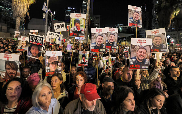 Protesters gather with signs showing portraits of Israeli hostages held in Gaza since Hamas's October 7 massacre during a demonstration calling for their release at Hostages Square in Tel Aviv, on December 9, 2023. (AHMAD GHARABLI / AFP)