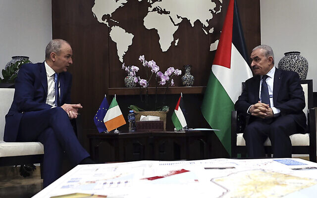 Irish Defense and Foreign Affairs Minister Micheal Martin, left, meets with Palestinian prime minister Mohammad Shtayyeh in the West Bank city of Ramallah on November 16, 2023. (Zain Jaafar/Pool Photo via AP)