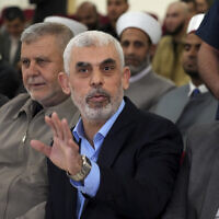 Yahya Sinwar, head of Hamas in Gaza, greets his supporters upon his arrival at a meeting in a hall on the sea side of Gaza City, on April 30, 2022. (AP Photo/Adel Hana, File)