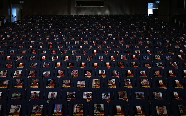 Photographs of over one thousand persons killed, missing or abducted in the Hamas attack on Israel on Oct. 7 are displayed on empty seats in an exhibit held under the motto "UNITED AGAINST TERRORISM" in the Smolarz Auditorium at Tel Aviv University on Oct. 22, 2023, in Tel Aviv. (AP Photo/Ohad Zwigenberg, File)