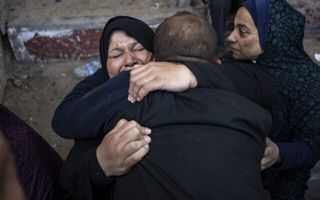 Palestinians mourn their relatives killed in fighting in the Gaza Strip, in the hospital in Khan Younis, Saturday, Dec. 2, 2023. (AP Photo/Fatima Shbair)