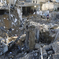 Palestinians look at destruction after an Israeli strike in Rafah, southern Gaza Strip, December 4, 2023. (AP Photo/Hatem Ali)