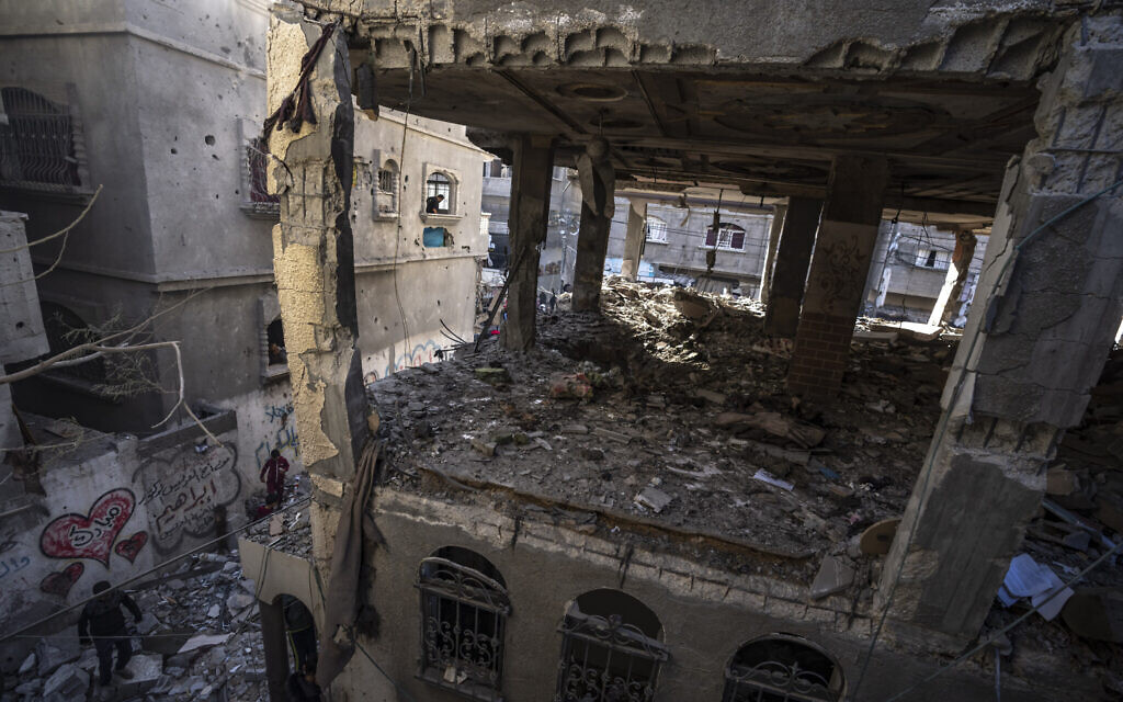Palestinians check a house destroyed in an Israeli strike on Rafah, Gaza Strip, Dec. 11, 2023. (AP Photo/Fatima Shbair)