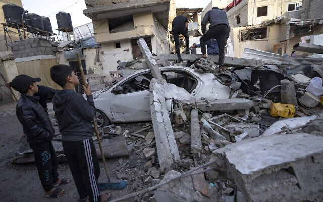Palestinians inspect a house after it was hit by an Israeli strike in Rafah, southern Gaza, Wednesday, Dec. 20, 2023. (AP/Fatima Shbair)