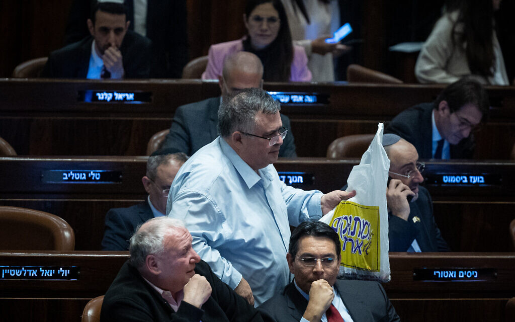Likud MKs Dudi Amsalem (left), David Bitan (standing center) and Danny Danon (right) seen during a vote in the assembly hall of the Knesset, February 15, 2023. (Yonatan Sindel/Flash90)