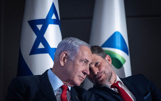 Prime Minister Benjamin Netanyahu, left, and Finance Minister Bezalel Smotrich at a press conference on the planned construction of a new railway line from the northern city of Kiryat Shmona to the city of Eilat, in Jerusalem, July 30, 2023. (Chaim Goldberg/Flash90)
