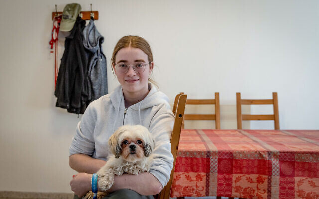 Mia Leimberg and her dog Bella who were released from Hamas captivity, at their home in Jerusalem, December 3, 2023. (Chaim Goldberg/Flash90)