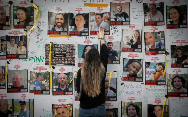 Israelis put up posters of the those held hostage by Hamas terrorists in Gaza, at 'Hostage Square' in Tel Aviv, December 6, 2023. (Miriam Alster/FLASH90)