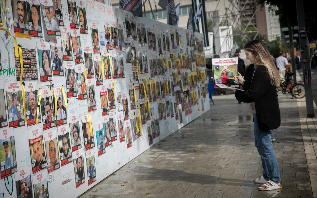 Israelis put up posters of the hostages by terrorists in Gaza, at 'Hostages Square' in Tel Aviv, December 6, 2023. (Miriam Alster/FLASH90)