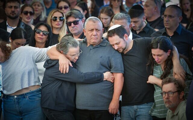 War cabinet minister and former IDF chief of staff Gadi Eisenkot, with family and friends, at the funeral of his son Gal, in Herzliya on December 8, 2023. Master Sgt. (res.) Gal Meir Eisenkot was killed  fighting in the Gaza Strip on December 7. (Avshalom Sassoni/Flash90)